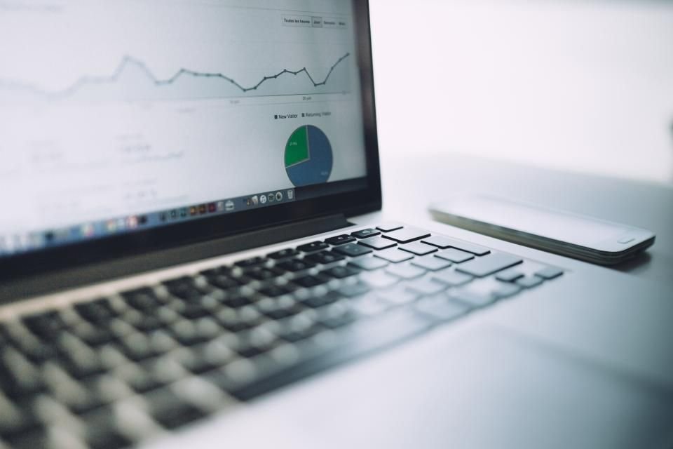 A laptop showing a website performance analytics chart