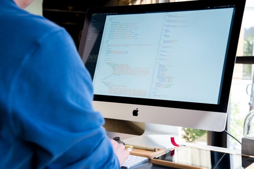 A software developer working at a desktop computer