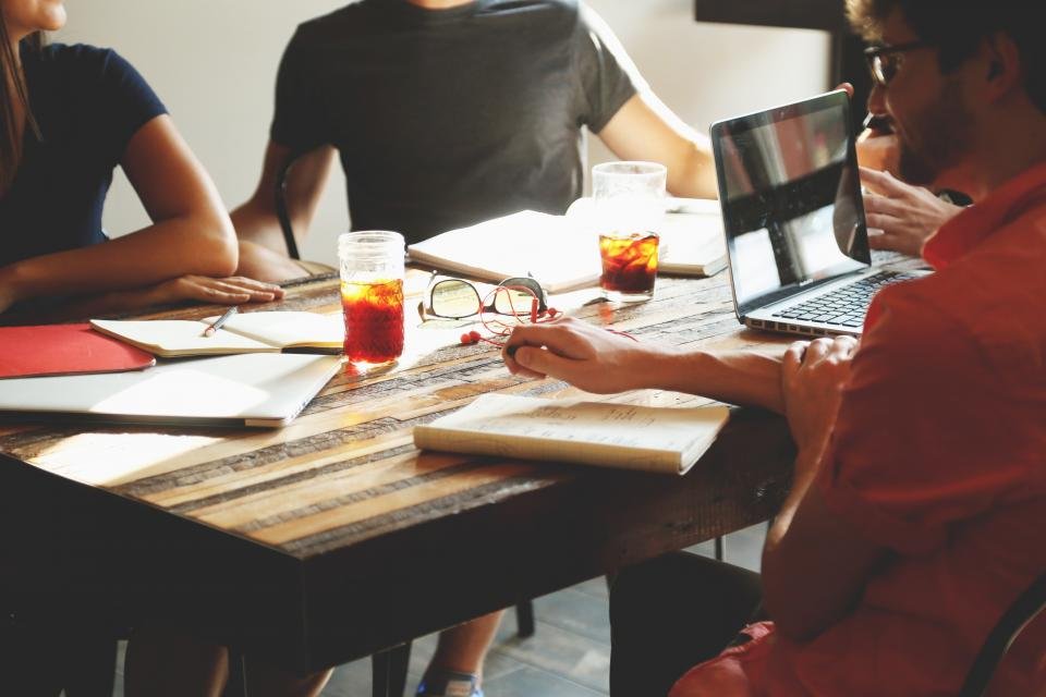 Business team meeting around a table discussing a web project