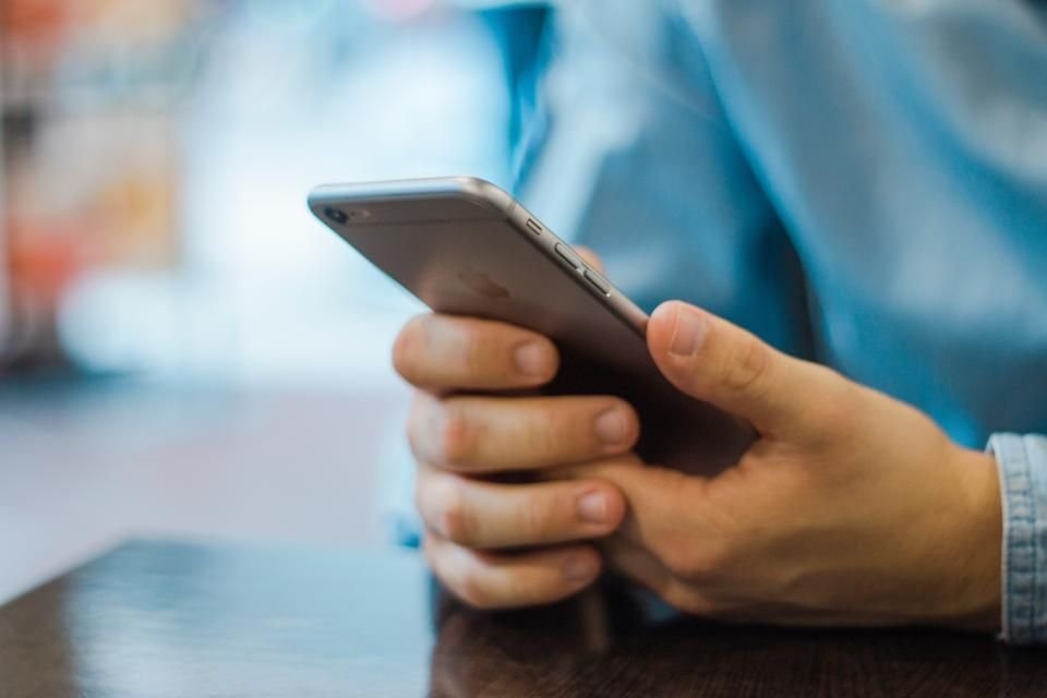 A person holding a smartphone and using an app