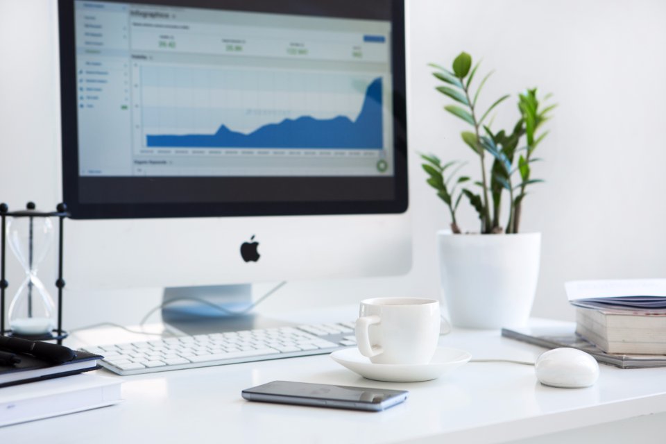 Laptop and monitor showing SEO analytics and traffic charts